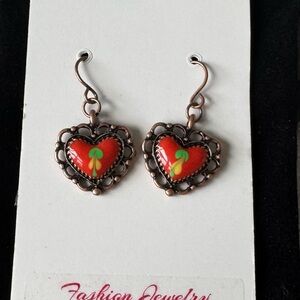 Copper plated heart shaped drop earrings, red centers.